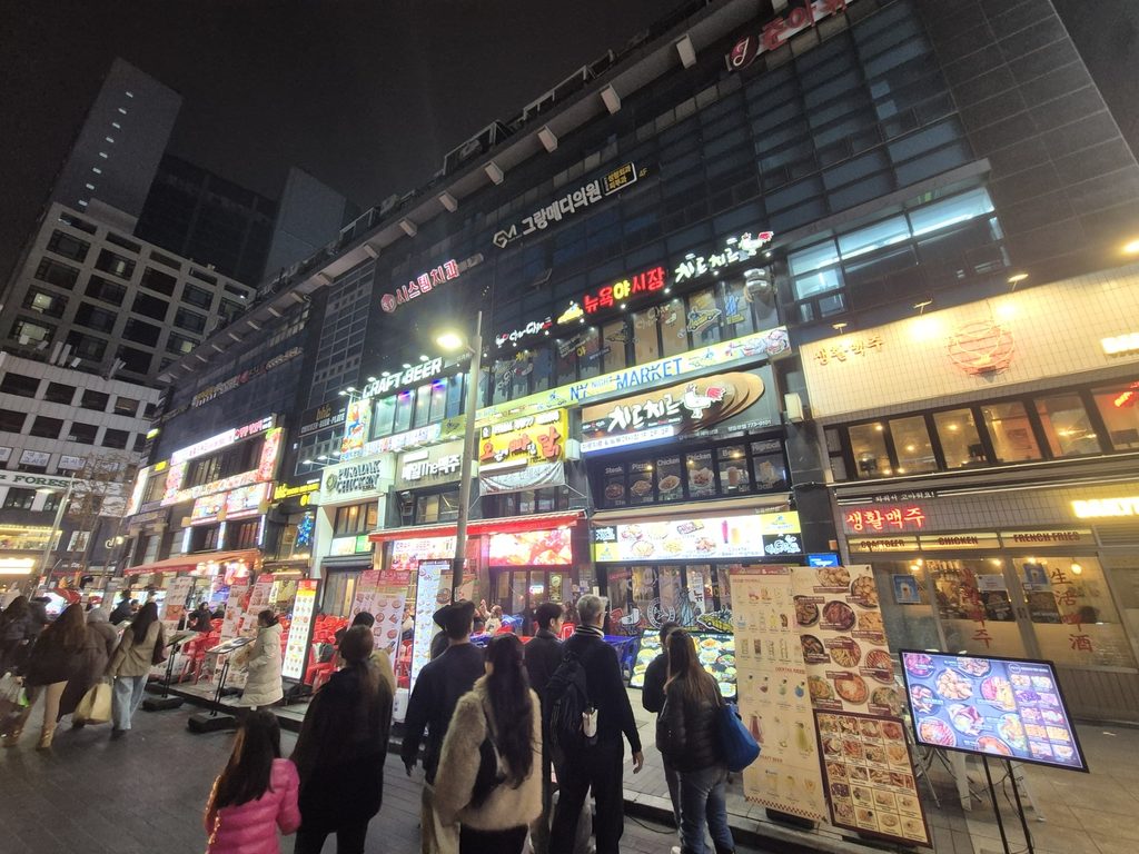 Busy restaurant street in Seoul on a cold December evening