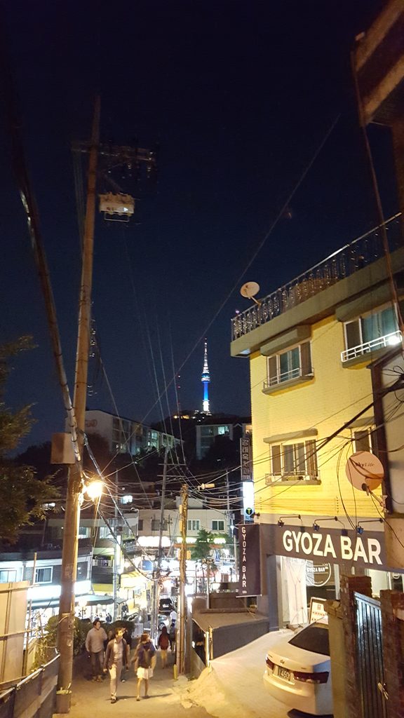 Seoul neighborhood at night with N Seoul Tower in the distance on an October evening