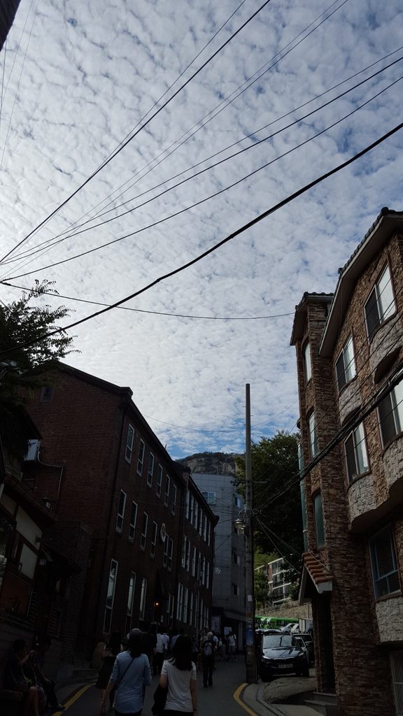 Early autumn clouds above a Seoul neighborhood in September