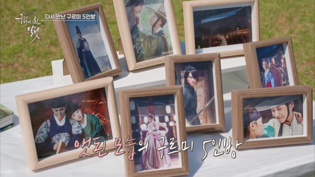 Framed scenes from Love in the Moonlight displayed during the cast reunion