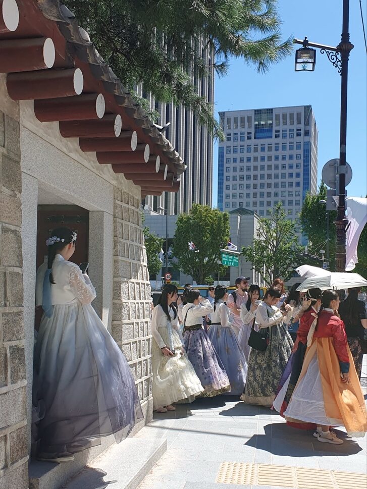 Visitors in colorful hanbok near the entrance to Gyeongbokgung Palace