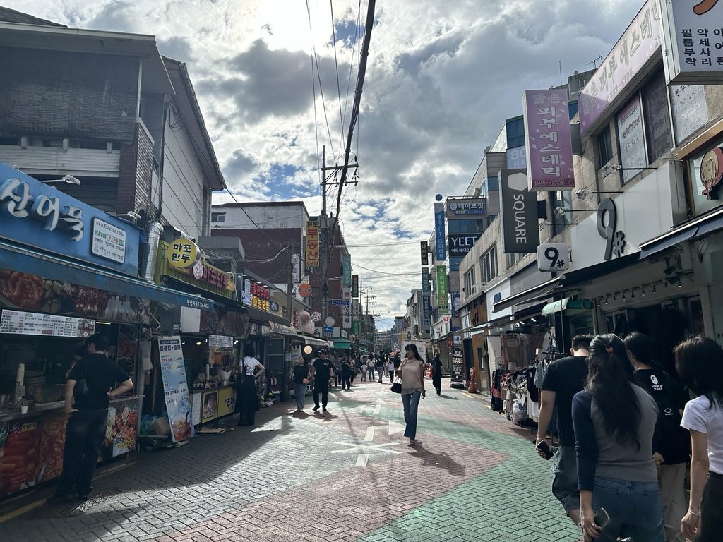 Local shops and pedestrians near Mangwon Market in Seoul